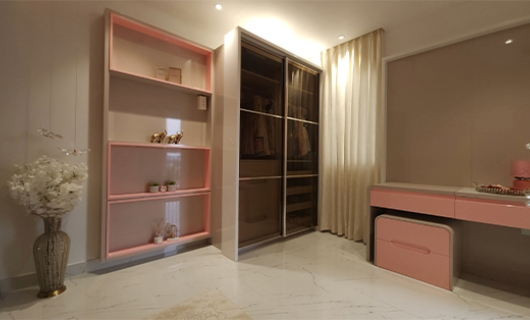 Modern glass wardrobe with sleek, reflective finish for stylish interiors.