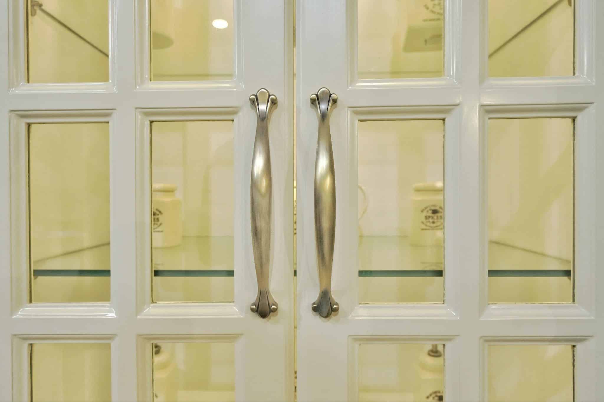 Classic Elegance: Brass Door Handle on PU Finished Glass Frame Shutters
